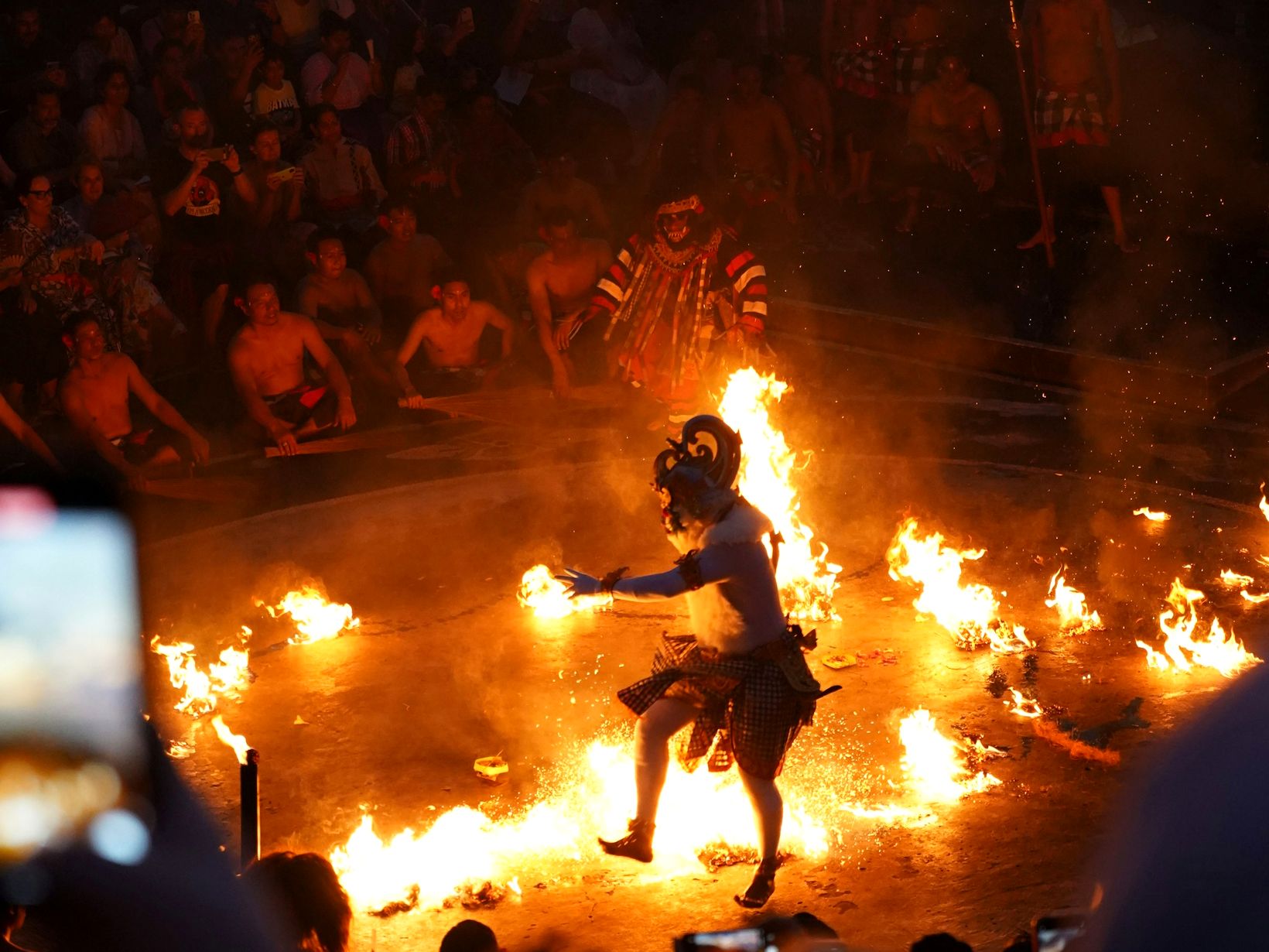 Balinese dancer performing at a sunset fire ceremony